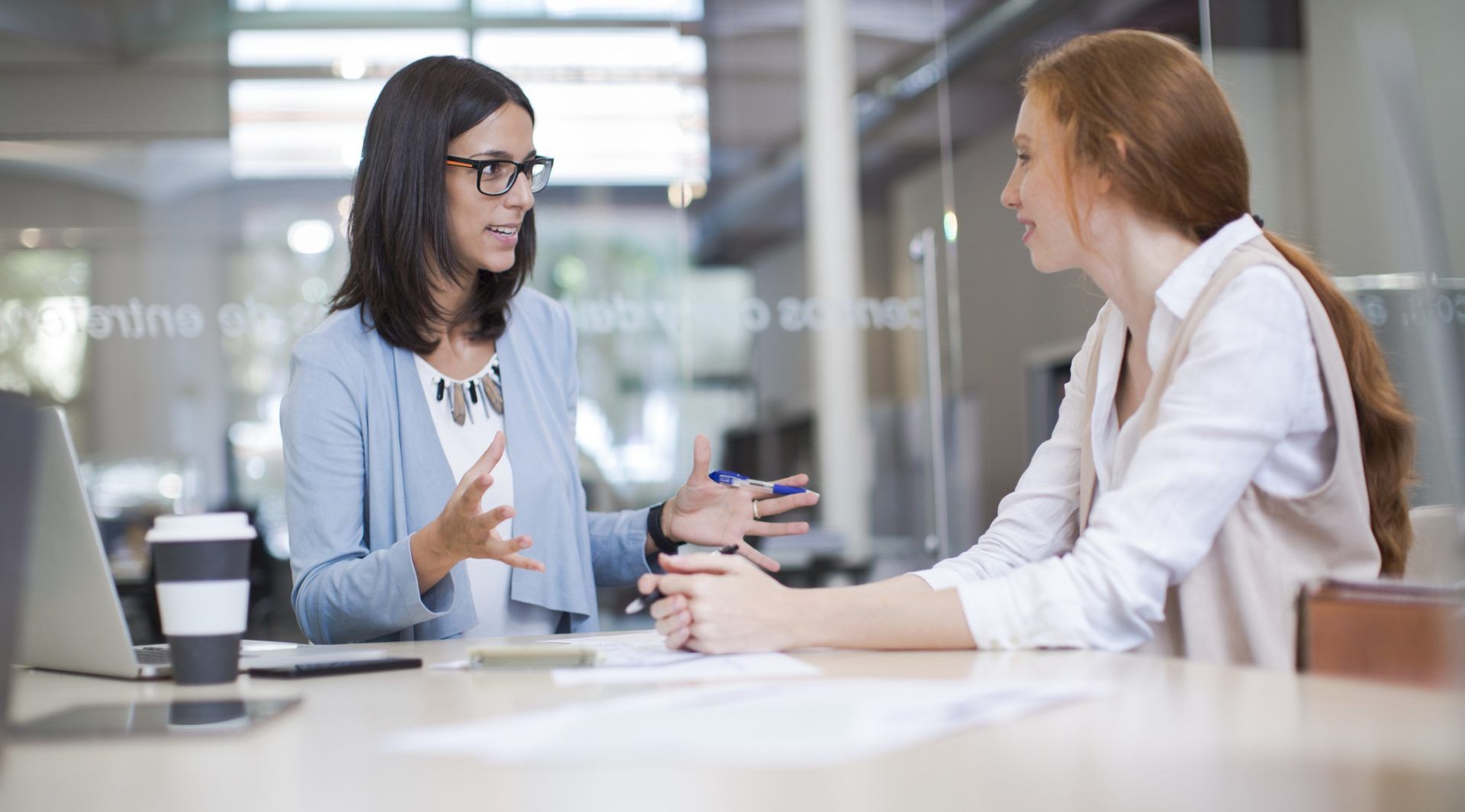 Coaching and advise, two business woman working together.